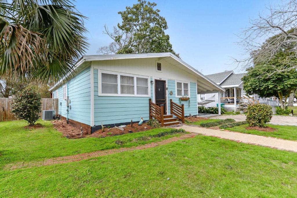 a blue and white house with a yard at Sandy Feet Getaway Spacious Coastal Retreat 3 MIn Walk to Coast in Gulfport