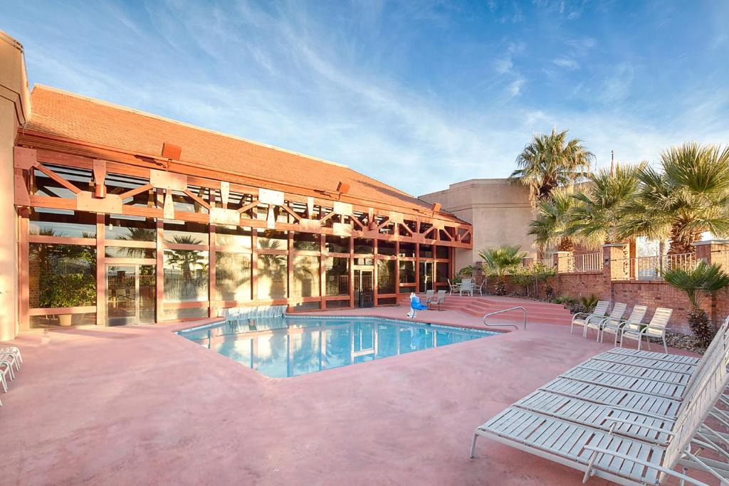 a large building with a swimming pool in front of it at Red Lion Hotel and Conference Center St. George in St. George