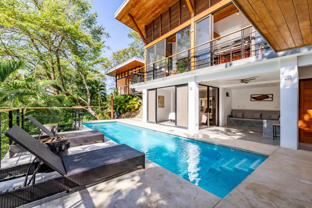 an exterior view of a house with a swimming pool at Casa Canopy in Nosara