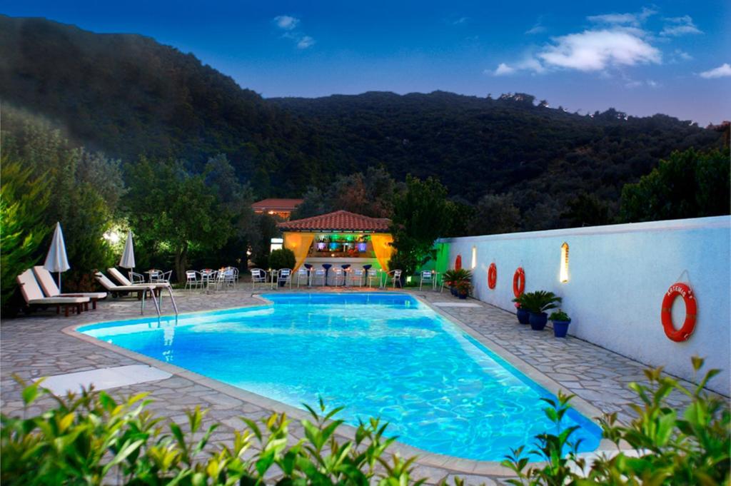 a swimming pool in the middle of a resort at Artemis Bungalows in Stafylos