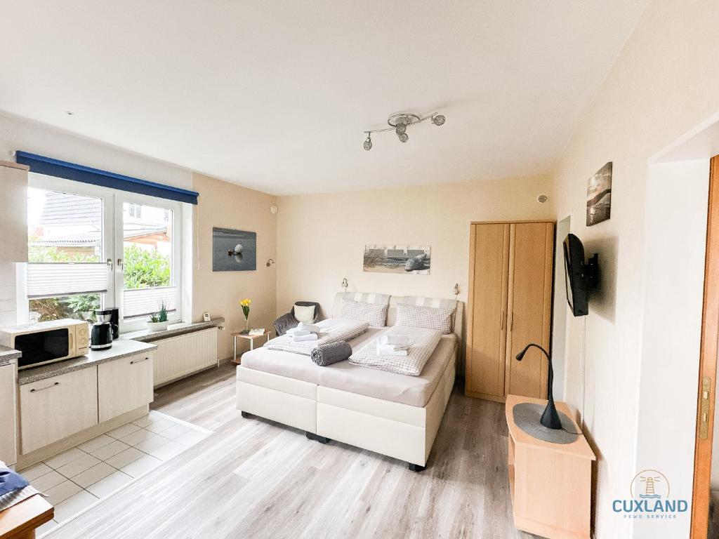 TV a/nebo společenská místnost v ubytování Ferienhaus Bungalow nahe Kurpark Döse