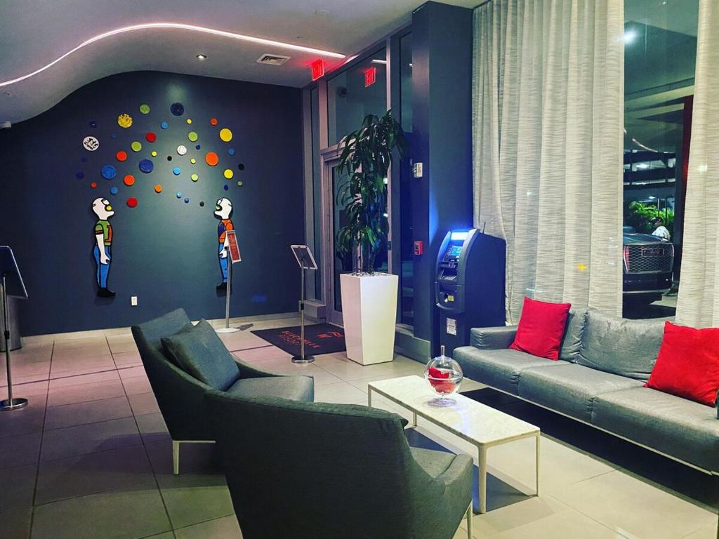 een woonkamer met 2 banken en een muur met een klimwand bij Beachfront Studio, 2 Full Beds, Dream View 2804 in Hallandale Beach