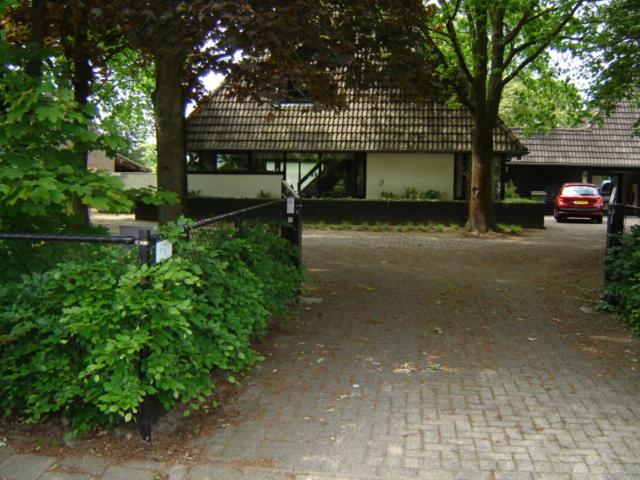 a house with a car parked in front of it at B&B van Dinter in Valkenswaard