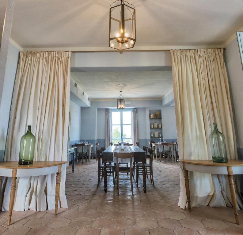 a dining room with a table and chairs and a window at Villa Sant'Angelo in Alba Adriatica
