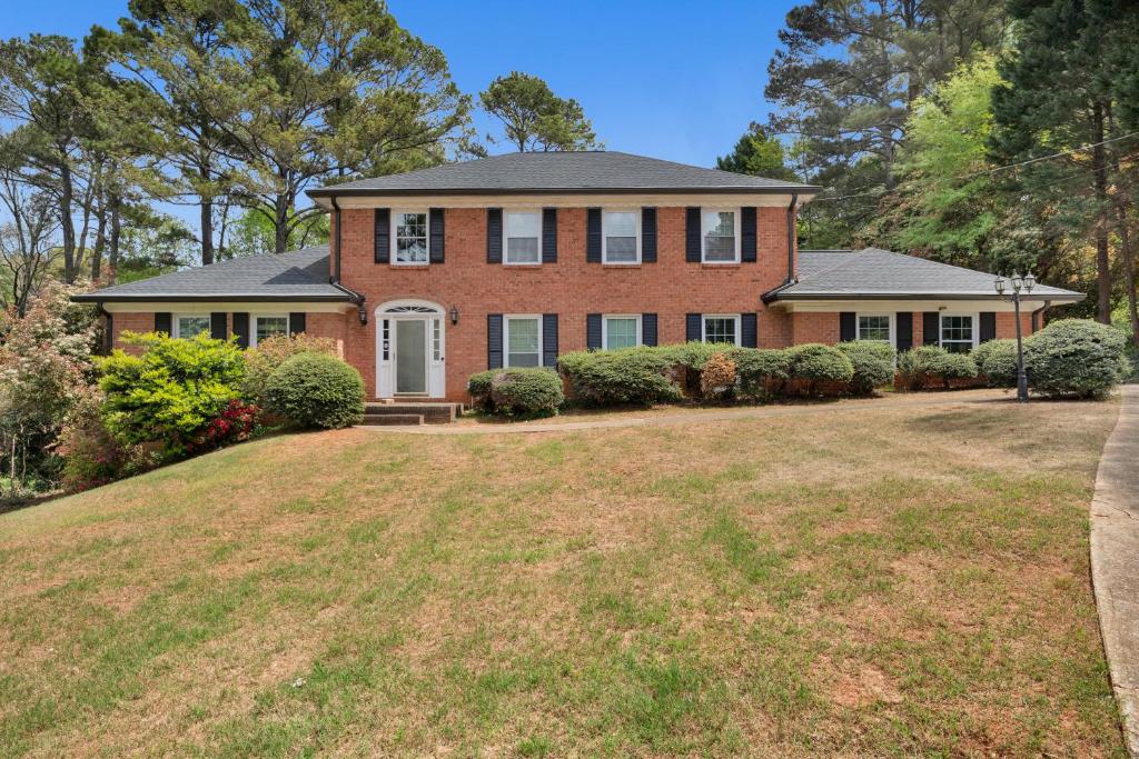 a large brick house with a large yard at 1 BR Suite w Fenced Backyard - Parking! in Tucker