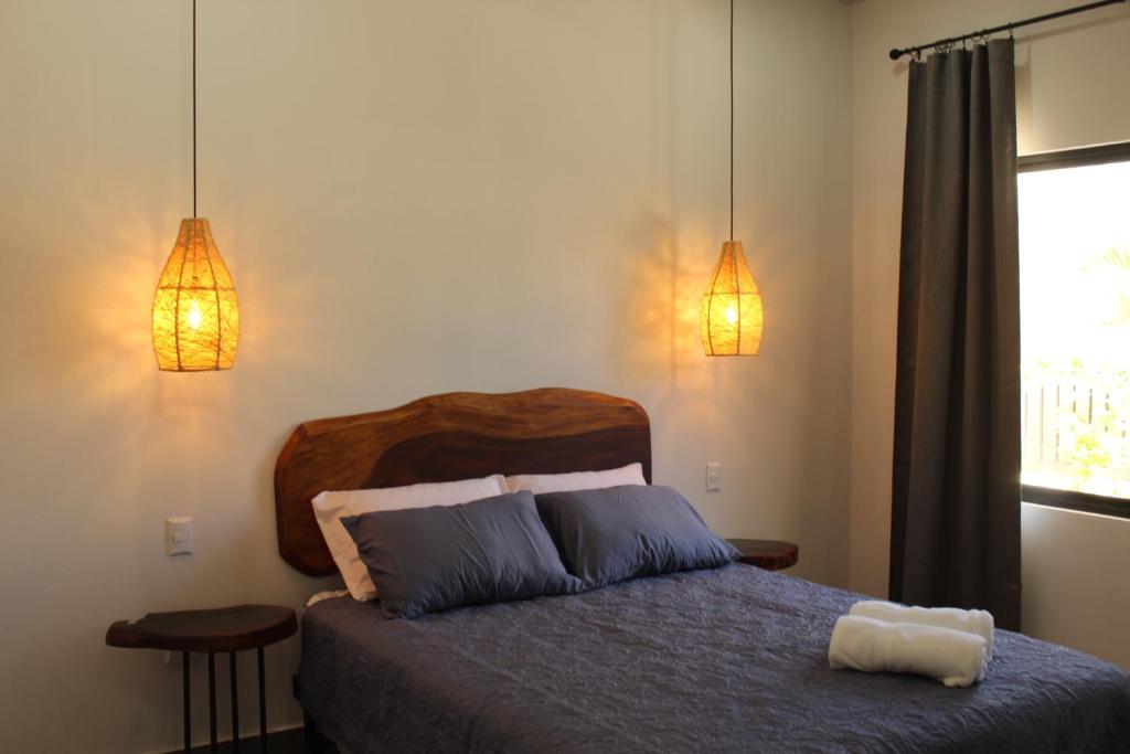Postel nebo postele na pokoji v ubytování Hotel Huacas