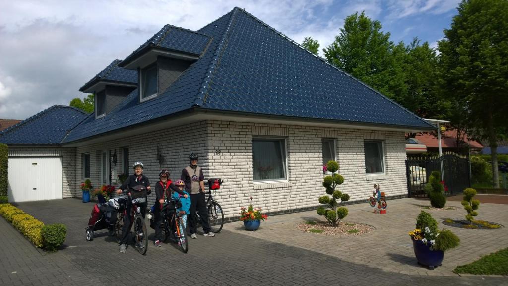 a group of people standing in front of a house at Privatpension Biker-Stop in Lathen