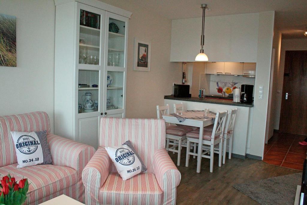 a living room and kitchen with two couches and a table at Meeresrauschen in Staberdorf