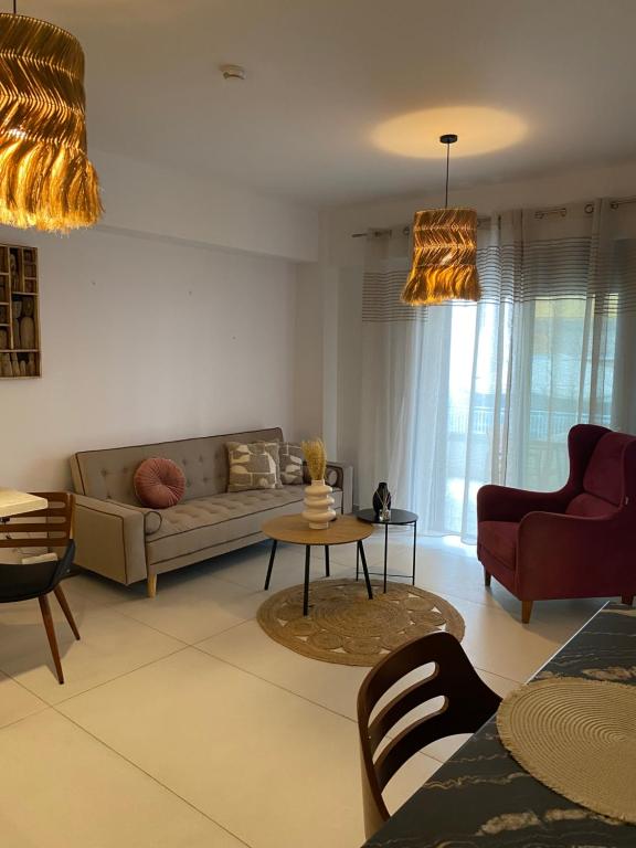 a living room with a couch and a table at NEW 2BD Aprt with Shared Rooftop Pool B3 in Athens