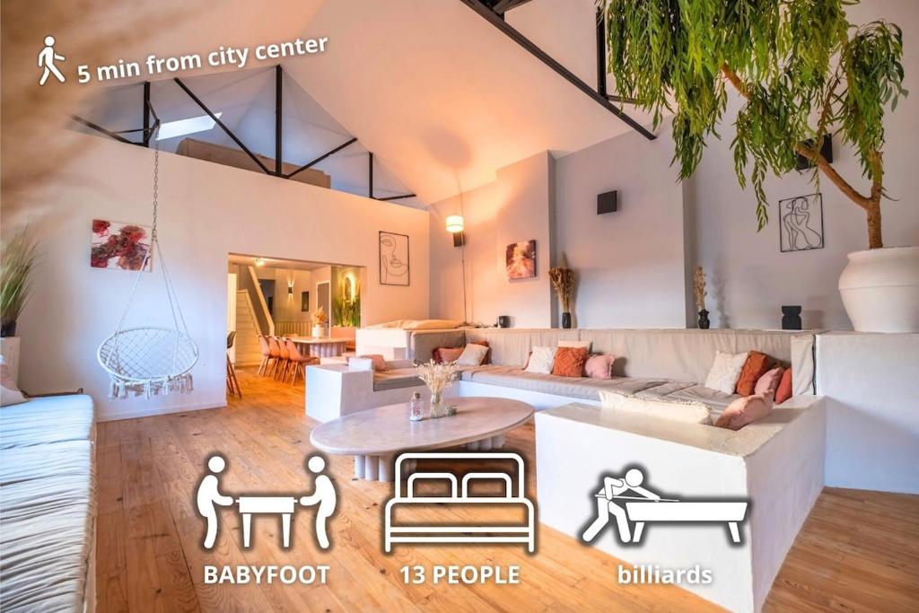 un soggiorno con un divano e un tavolo di Le Loft Triplex 200M2 avec billard au centre-ville a Épernay