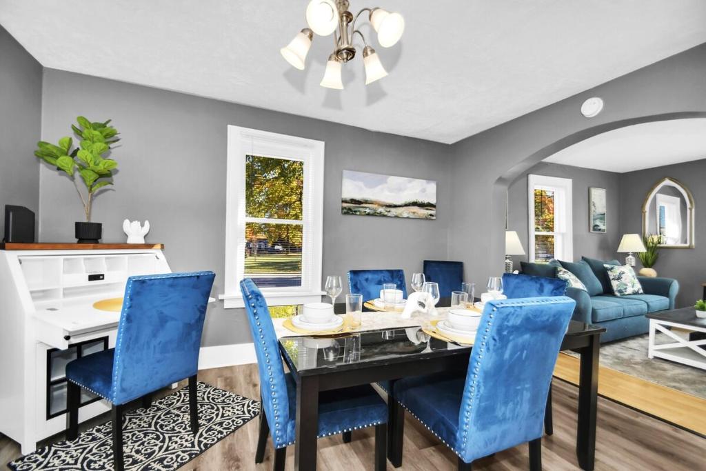 a dining room with a table and blue chairs at A-Frame Charmer in Town, Newly Renovated in LaPorte