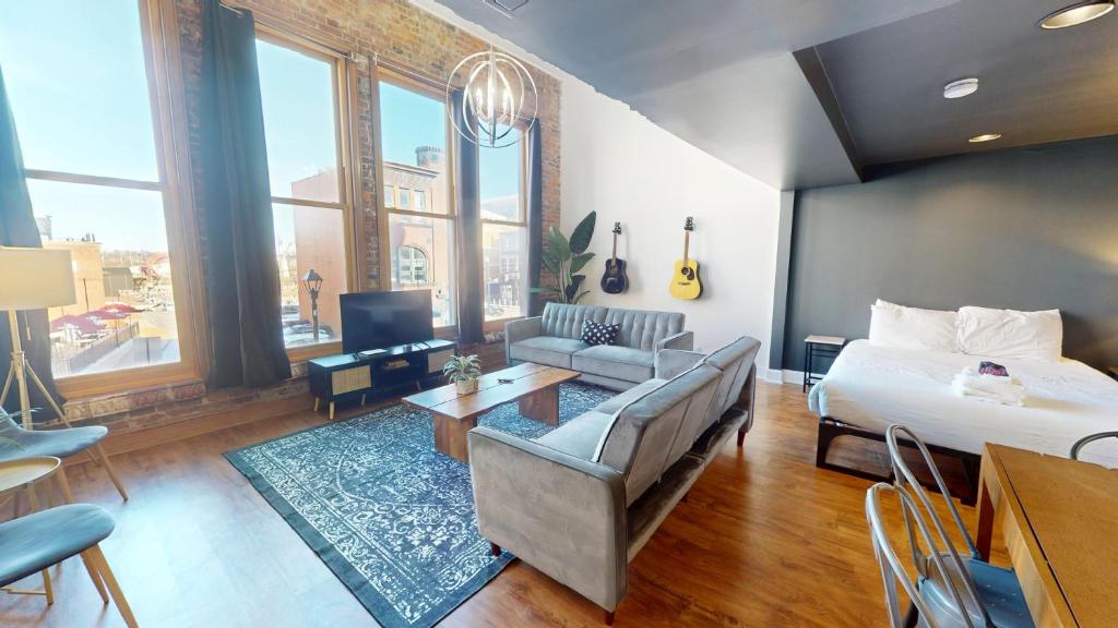 a living room with a bed and a couch at The Lofts at 107 in Nashville