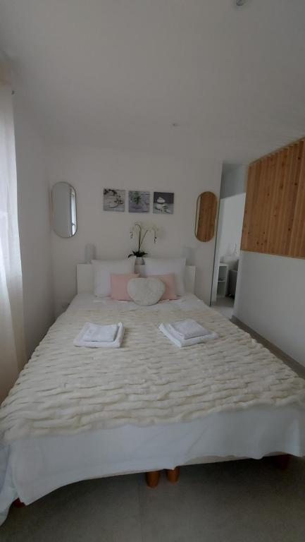 a bedroom with a large bed with two towels on it at Chez Marie in Vannes