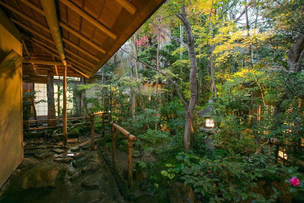 an outside view of a house in a forest at Gion Yoshiima in Kyoto