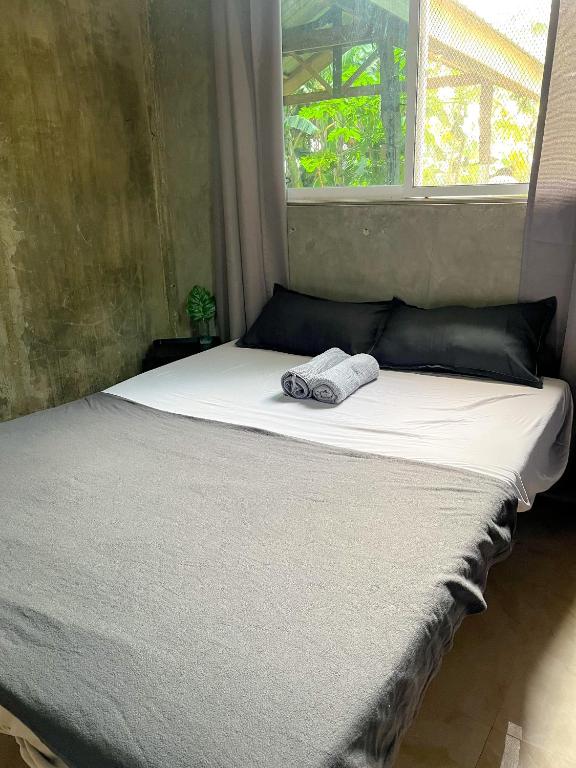 a bed with a towel on it in front of a window at Istaran Stays - Burgos in Burgos