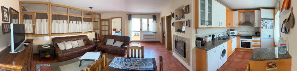 a large living room with a couch and a kitchen at Casa Rural Mayoral (Barriopedro) in Barriopedro
