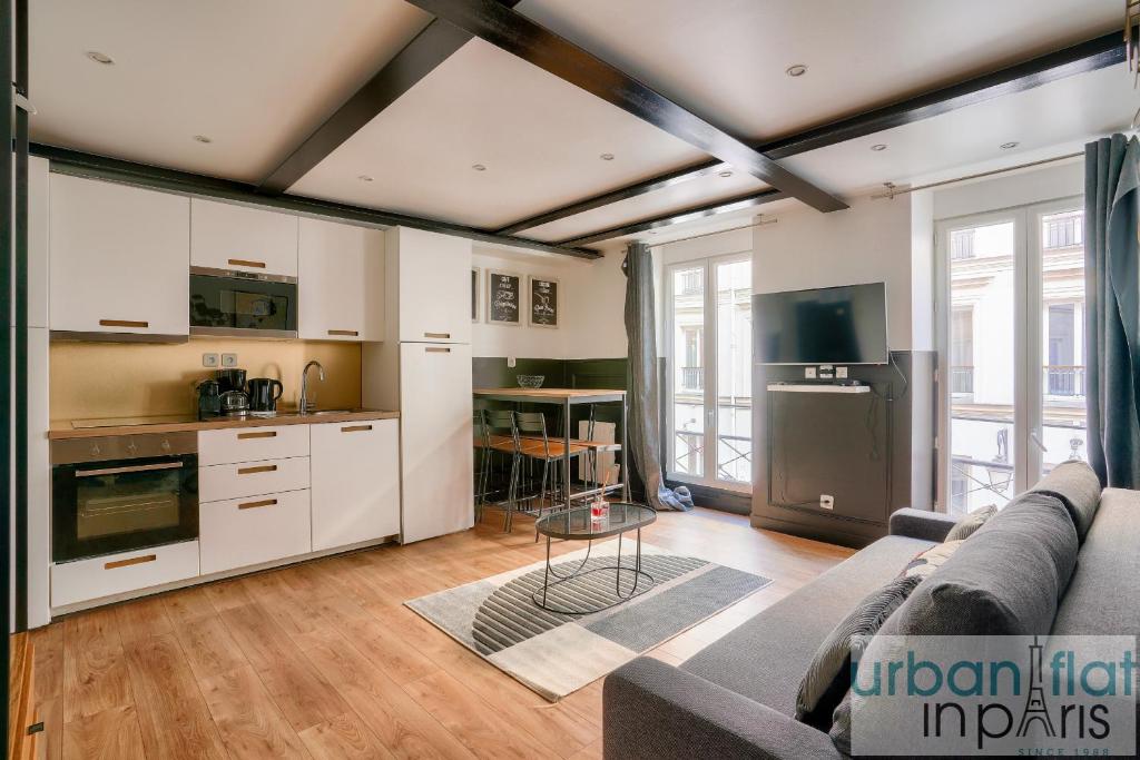 un salon avec un canapé et une cuisine dans l'établissement 13 Luxury Flat eiffel design 2, à Paris