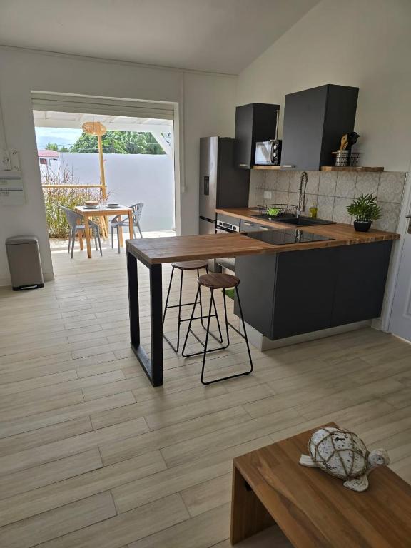 a kitchen with a table and a kitchen with a table at Appartement au centre de Gosier 7 in Le Gosier