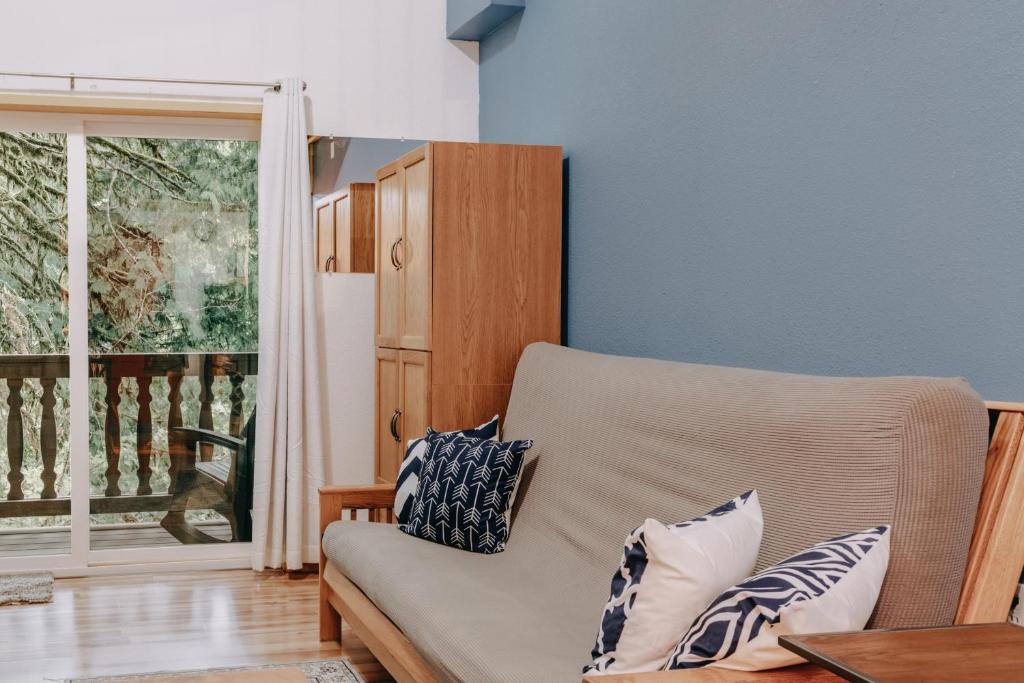 a living room with a couch and a window at Snowline Lodge Condo 18 - Beautifully Remodeled! in Glacier
