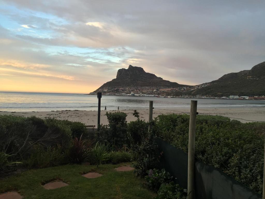a view of a beach with a mountain in the background at On the Beach in Hout Bay