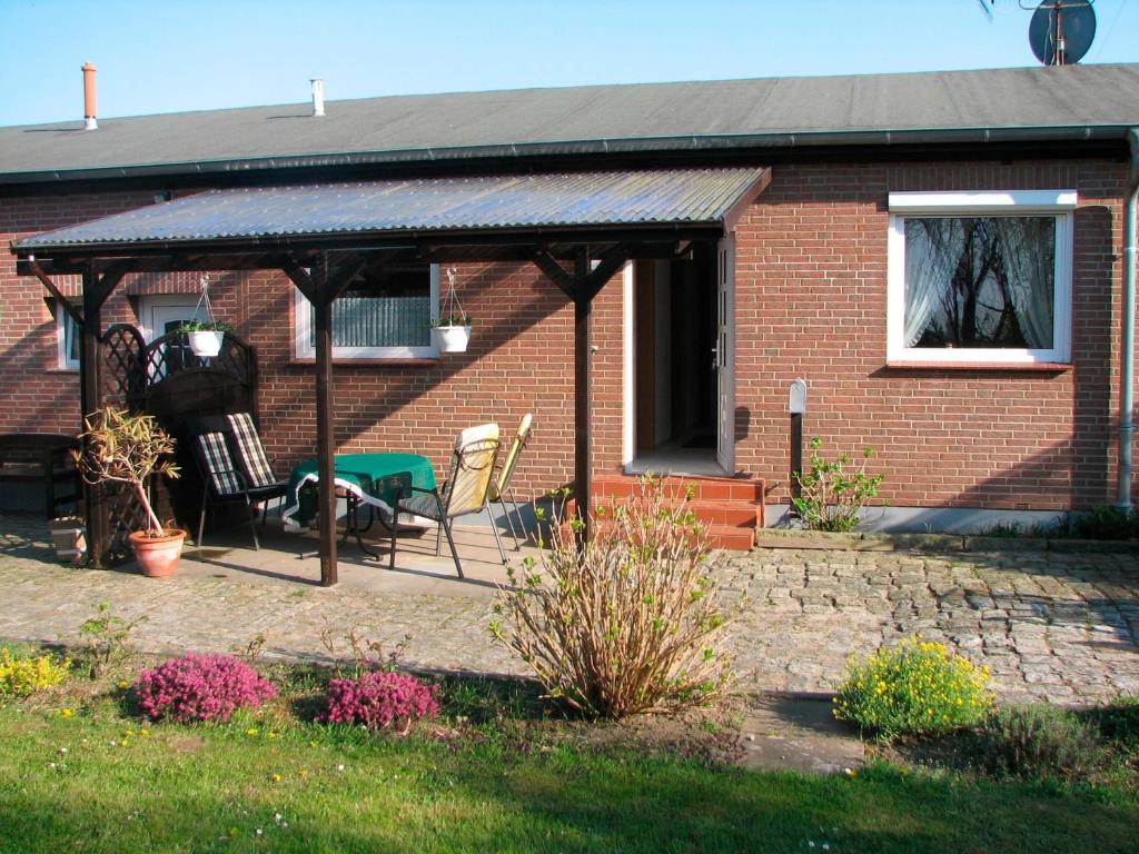 a brick house with a gazebo in the yard at Hering in Grossenbrode