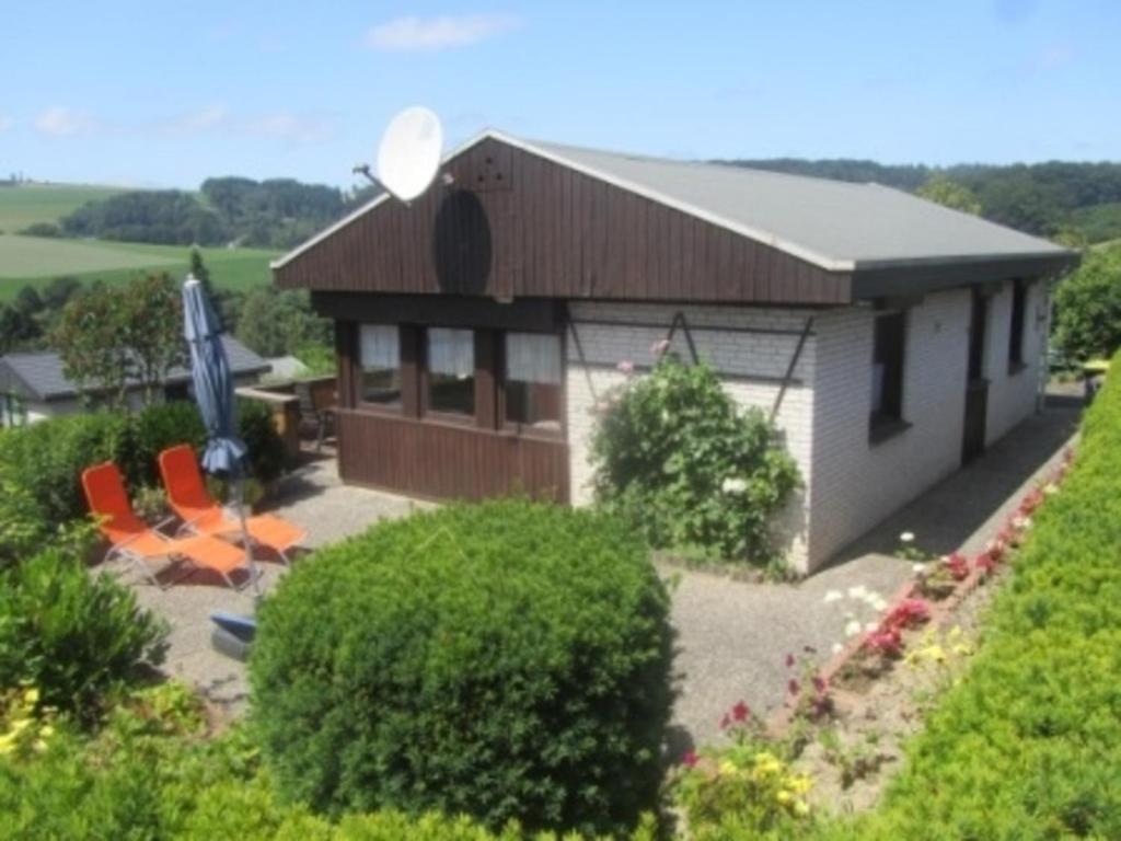 an aerial view of a building with chairs and an umbrella at Ferienhaus Bianca in Meschede