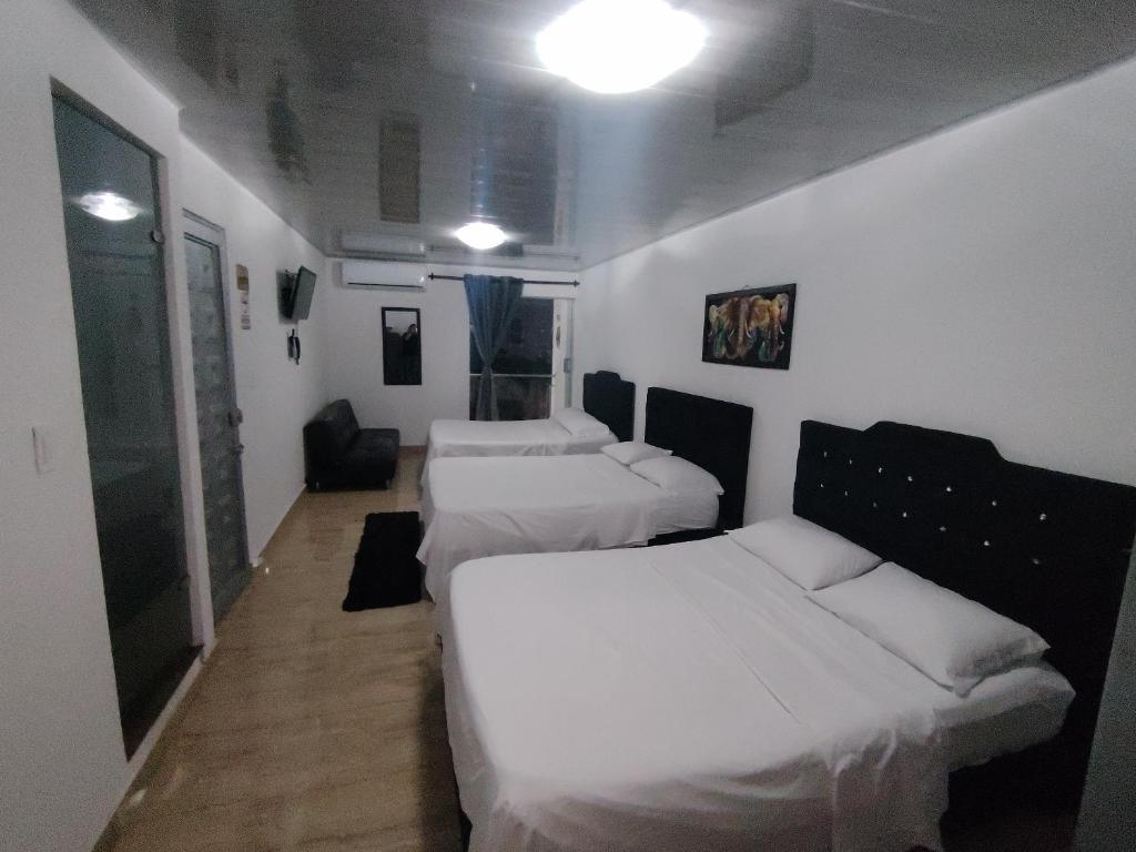 Postel nebo postele na pokoji v ubytování Hotel Palmari