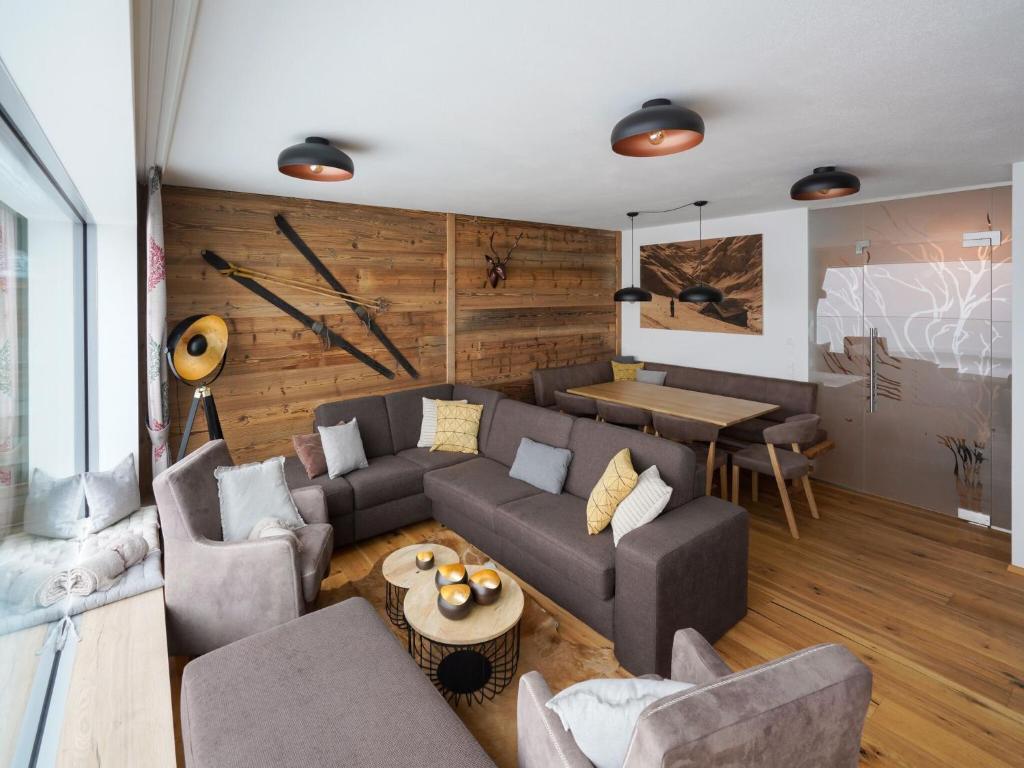 a living room with a couch and a table at Kitzbühel alpine lodge with sauna in Mittersill