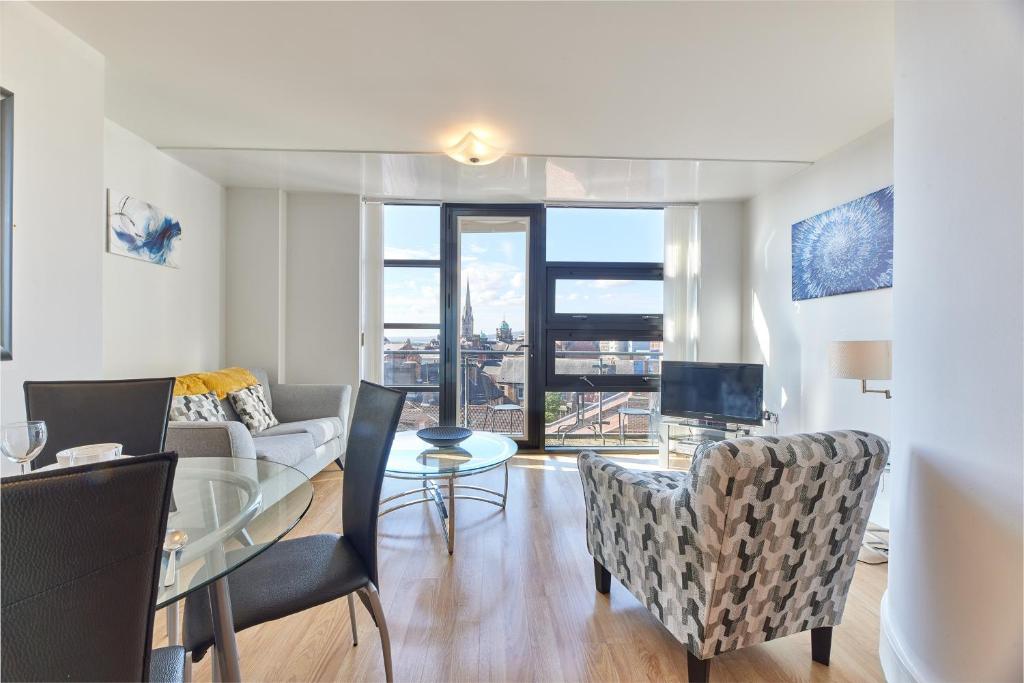 a living room with a couch and a table with chairs at Low Friars - Properties Unique in Newcastle upon Tyne
