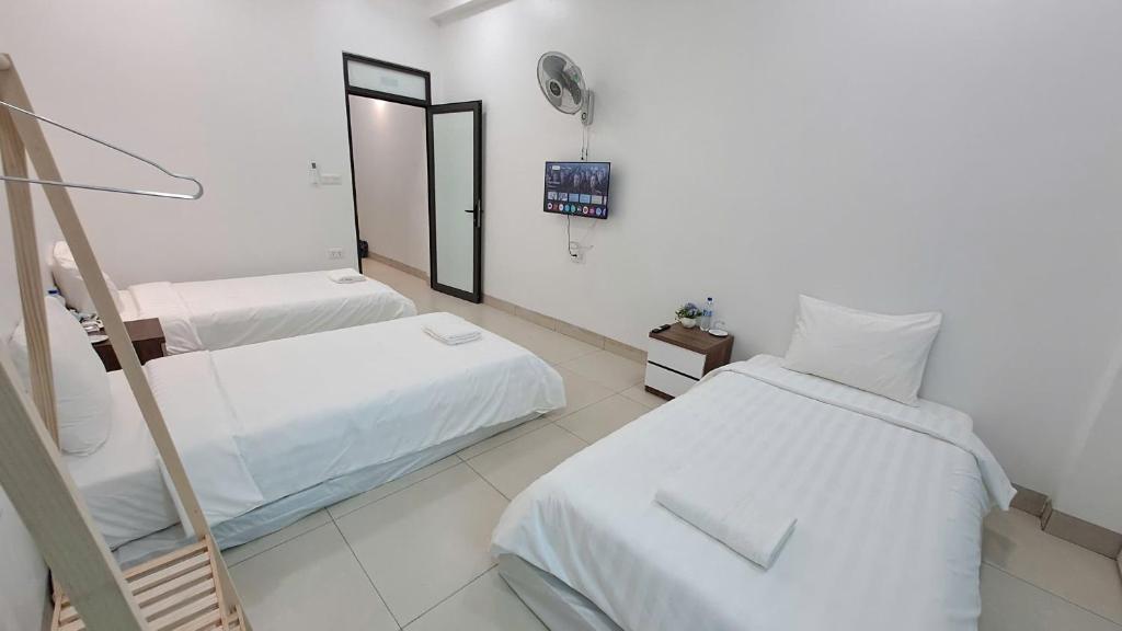 Postel nebo postele na pokoji v ubytování HT Airport Inn