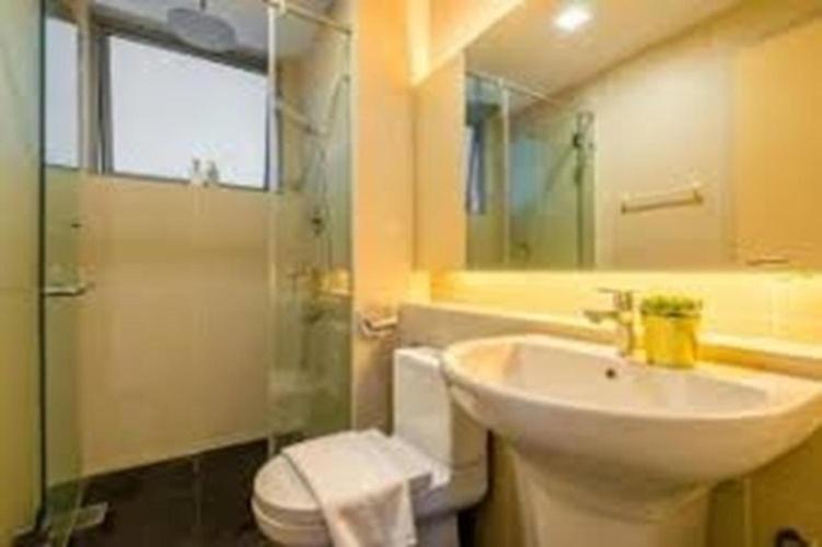 a bathroom with a sink and a toilet and a mirror at Luxury Homestay Rooms with Balcony in Kuala Lumpur
