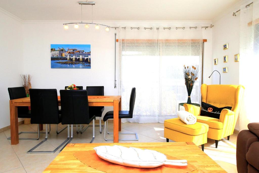 a living room with a dining room table and chairs at Apartment Karin, Town Centre in Tavira