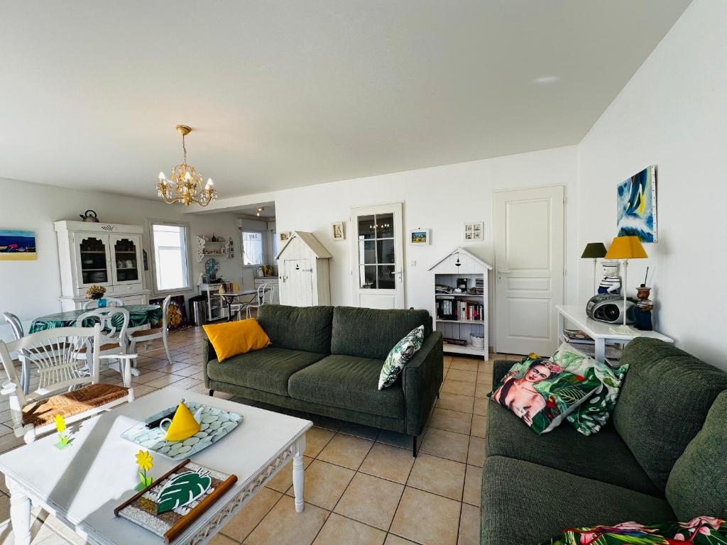 un salon avec un canapé et une table dans l'établissement Maison lumineuse à Fouras, proche mer, 6 pers, 3 ch, jardin - FR-1-709-89, à Fouras