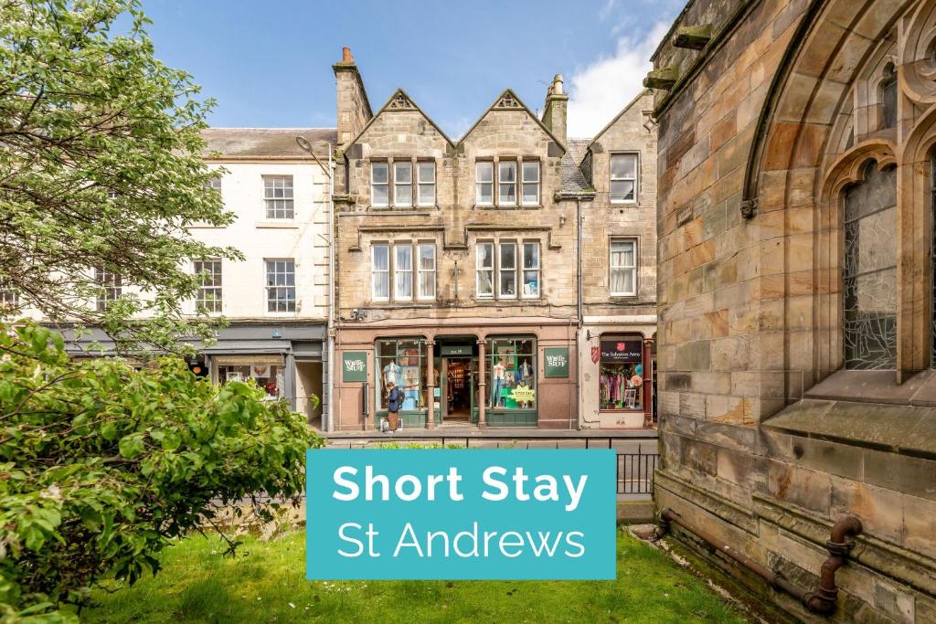a building with a sign that says short stay st andrews at Spire View Apartment in St. Andrews