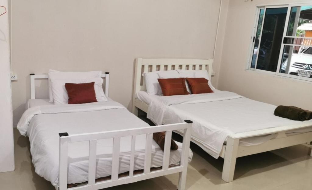 Postel nebo postele na pokoji v ubytování M-Plus Homestay Sukhothai