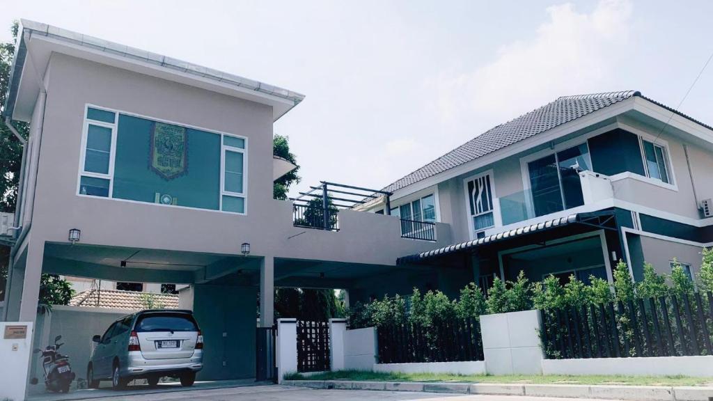 a house with a car parked in front of it at A,B house Chiangmai in Chiang Mai