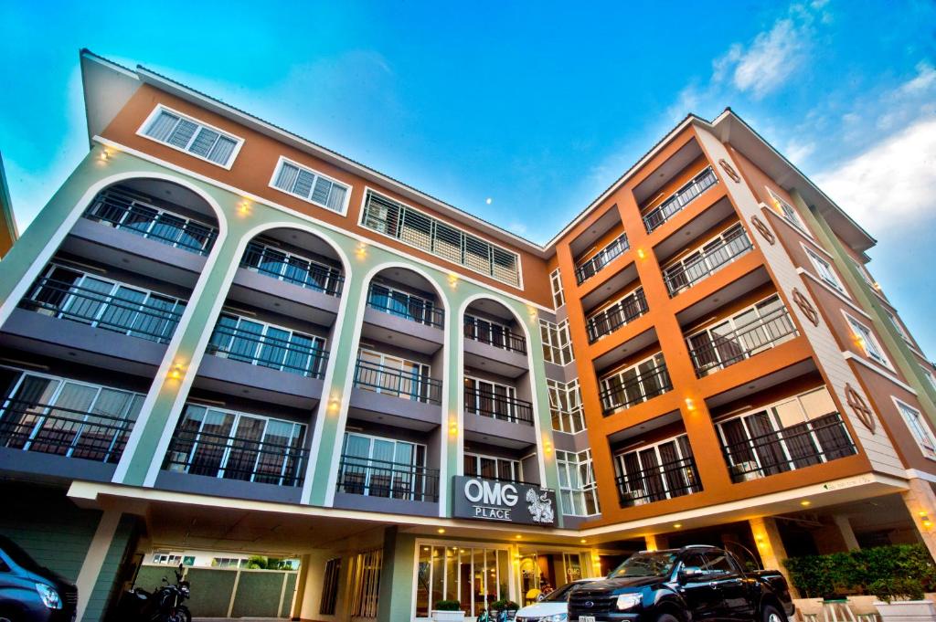 a building with a car parked in front of it at OMG Hotel in Khon Kaen