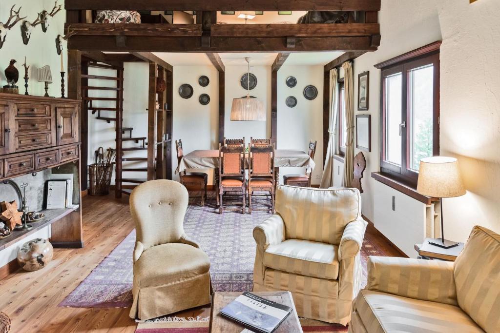 a living room with a couch and chairs and a table at Chesa Martina - La Punt in La Punt-Chamues-ch