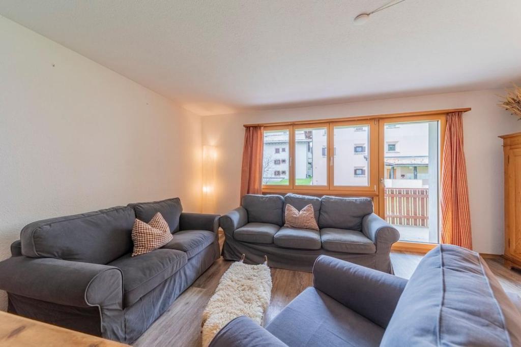a living room with a couch and two couches at Chesa La Giunfra - Celerina in Celerina