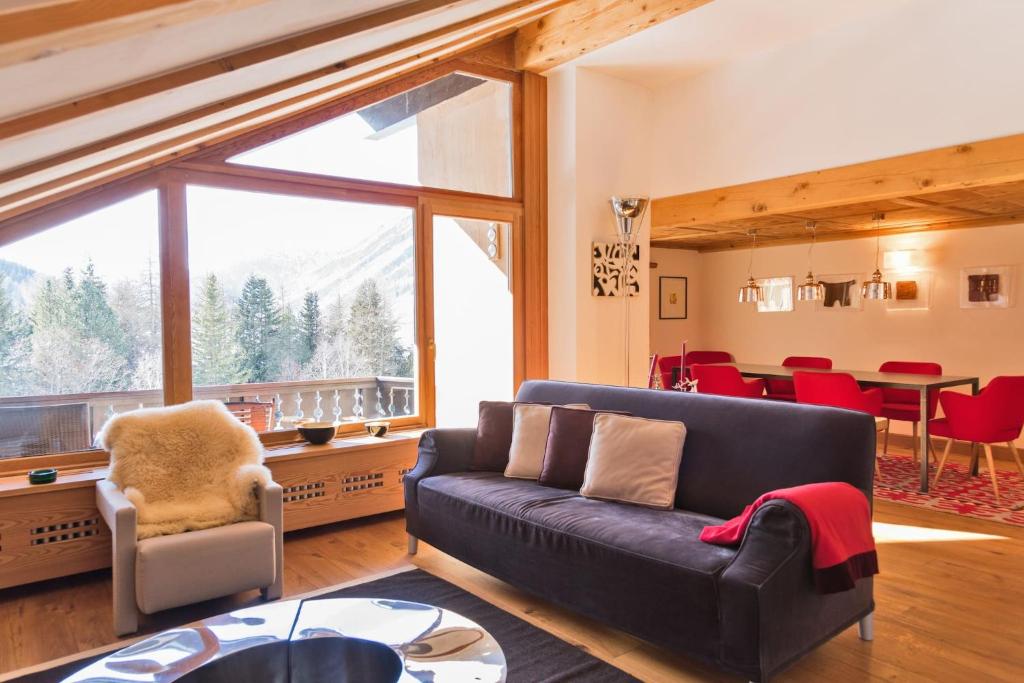 a living room with a couch and a table at Chesa Valluna - La Punt-Chamues-ch in La Punt-Chamues-ch