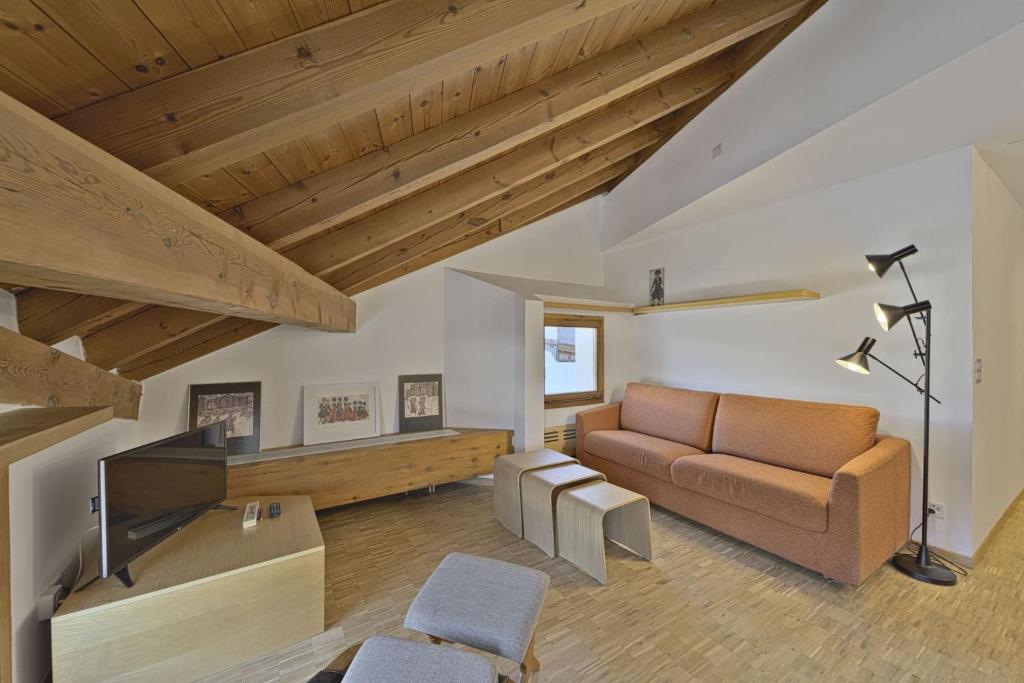a living room with a couch and a table at Chesa Pitz Alv - Pontresina in Pontresina