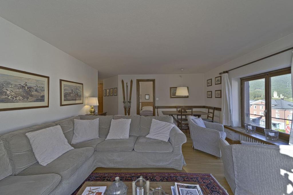 a living room with a couch and a table at Chesa Centrum - Celerina in Celerina