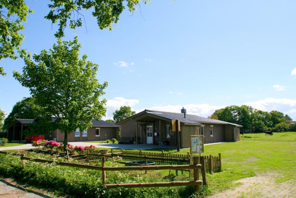 une maison avec une clôture devant dans l'établissement Bauernhof Sauer - Kötterhus, à Varel