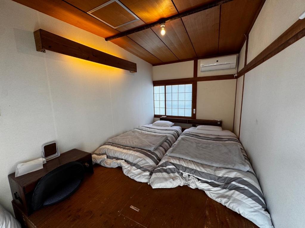 Postel nebo postele na pokoji v ubytování Roku Hostel Hiroshima