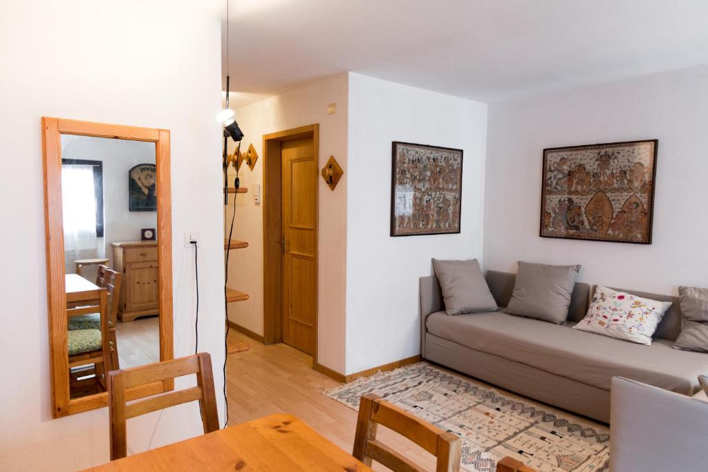 a living room with a couch and a table at Chesa Tschierv - Celerina in Celerina