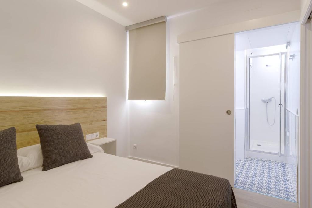 A bed or beds in a room at Ola Living Camp Nou