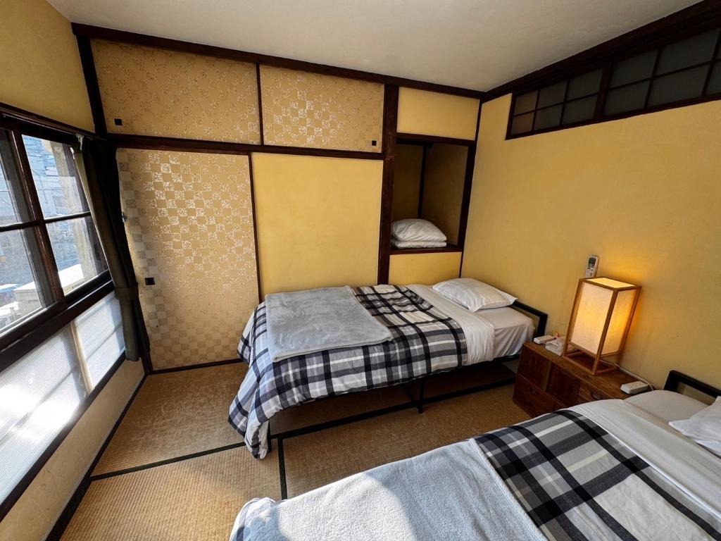 Postel nebo postele na pokoji v ubytování Roku Hostel Hiroshima
