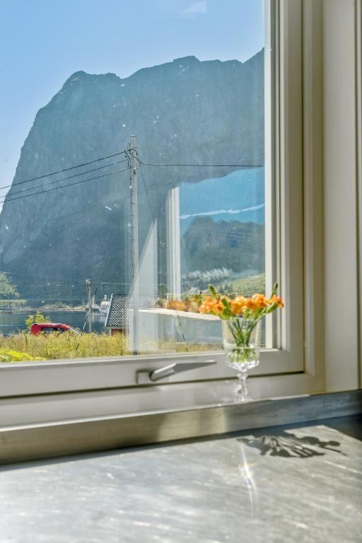 a vase of flowers sitting on a window sill at Valen House, Reine in Reine
