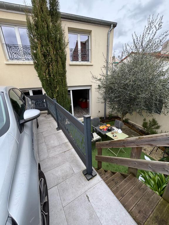 a car parked in front of a house at L Olivier in Nanterre