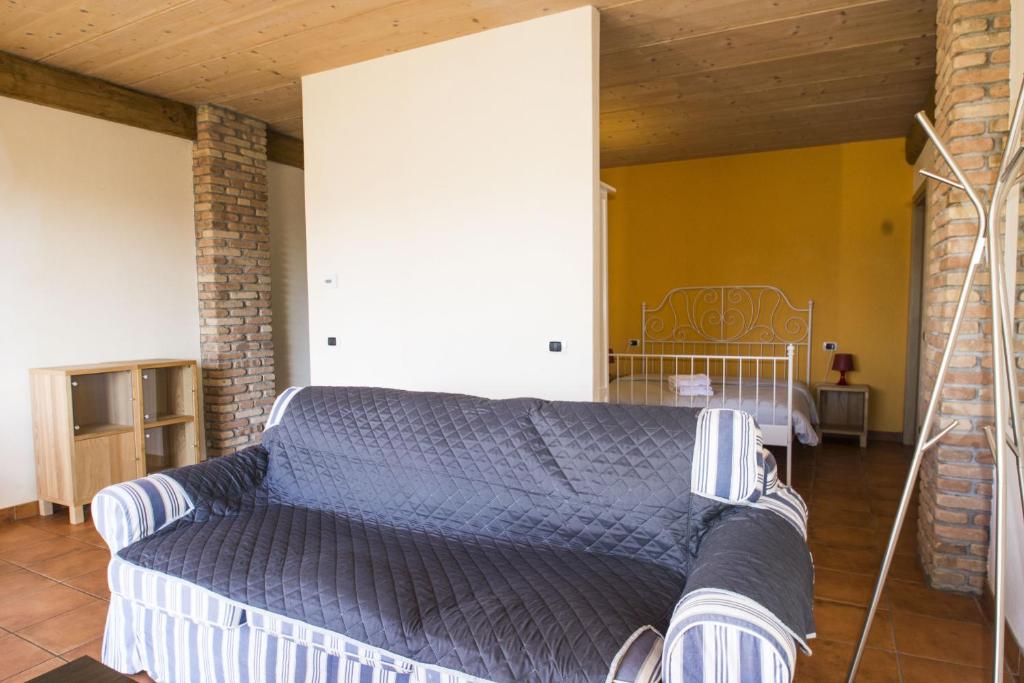 a bedroom with a bed with a blue comforter at Cascina Cadorna 2 in Montegrino Valtravaglia